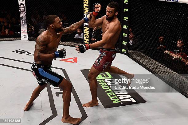 Michael Johnson of the United States punches Edson Barboza of Brazil in their lightweight bout during the UFC Fight Night at Gigantinho Gymnasium on...