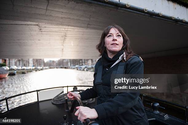 female captain passing a low bridge - boat captain 個照片及圖片檔