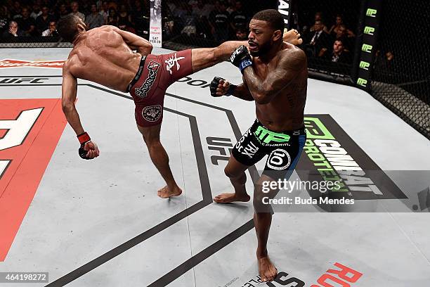 Edson Barboza of Brazil kicks Michael Johnson of the United States in their lightweight bout during the UFC Fight Night at Gigantinho Gymnasium on...