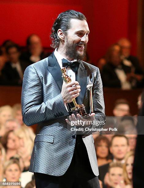 Actor Matthew McConaughey prepares to present winner Julianne Moore her statuette during the 87th Annual Academy Awards at Dolby Theatre on February...