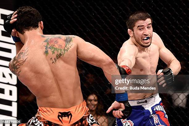 Rustam Khabilov of the Russian punches Adriano Martins of Brazil in their lightweight bout during the UFC Fight Night at Gigantinho Gymnasium on...
