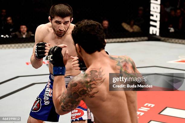 Rustam Khabilov of the Russian punches Adriano Martins of Brazil in their lightweight bout during the UFC Fight Night at Gigantinho Gymnasium on...