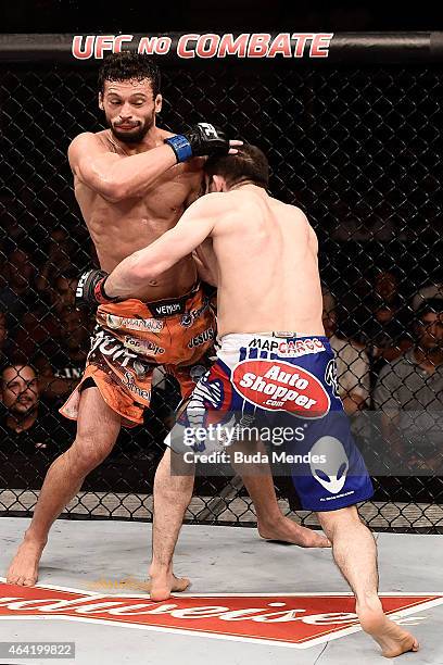 Rustam Khabilov of the Russian punches Adriano Martins of Brazil in their lightweight bout during the UFC Fight Night at Gigantinho Gymnasium on...