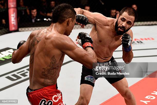 Frankie Saenz of the United States punches Iuri Alcantara of Brazil in their bantamweight bout during the UFC Fight Night at Gigantinho Gymnasium on...