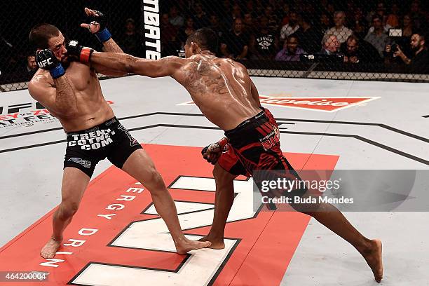 Iuri Alcantara of Brazil punches Frankie Saenz of the United States in their bantamweight bout during the UFC Fight Night at Gigantinho Gymnasium on...