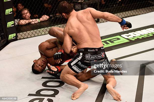 Frankie Saenz of the United States punches Iuri Alcantara of Brazil in their bantamweight bout during the UFC Fight Night at Gigantinho Gymnasium on...