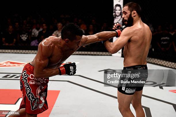 Iuri Alcantara of Brazil punches Frankie Saenz of the United States in their bantamweight bout during the UFC Fight Night at Gigantinho Gymnasium on...