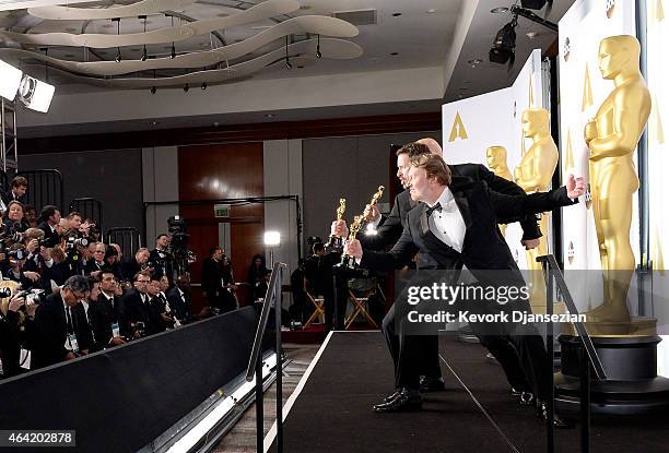 Chris Williams, Roy Conli, and Don Hall, winners of the Best Animated Feature Award for 'Big Hero 6', pose in the press room during the 87th Annual...