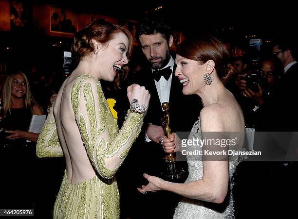 Actress Emma Stone, Bart Freundlich, and actress Julianne Moore, winner of Best Actress in a Leading Role Award for 'Still Alice,' attend the 87th...