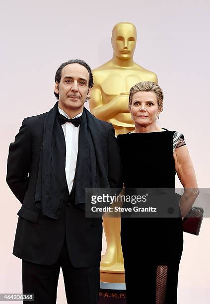 Composer Alexandre Desplat and film score producer Dominique Lemonnier attend the 87th Annual Academy Awards at Hollywood & Highland Center on...
