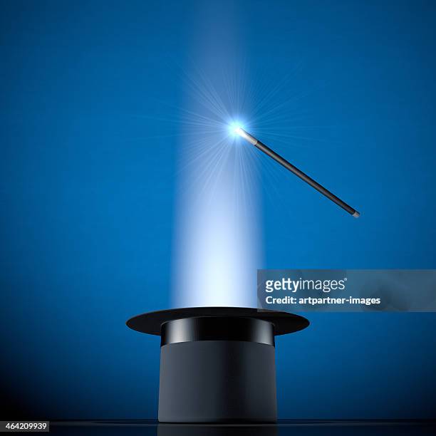 glowing magic wand and a black cylinder - magic wand stock pictures, royalty-free photos & images