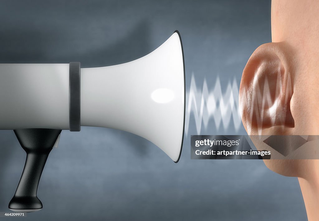 Megaphone yelling in front of an ear