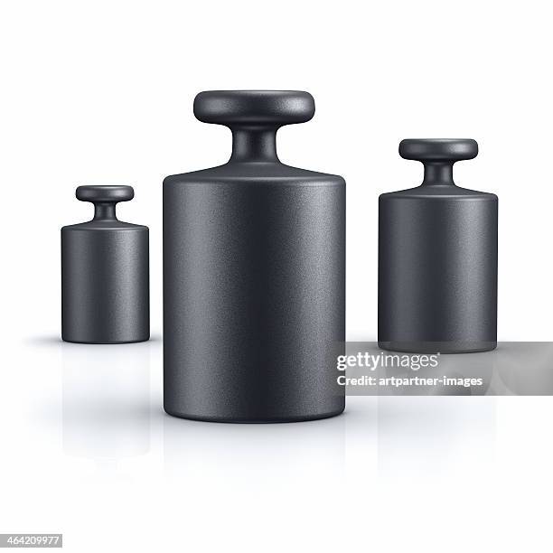 black weights of different size on white - gewicht meeteenheid stockfoto's en -beelden
