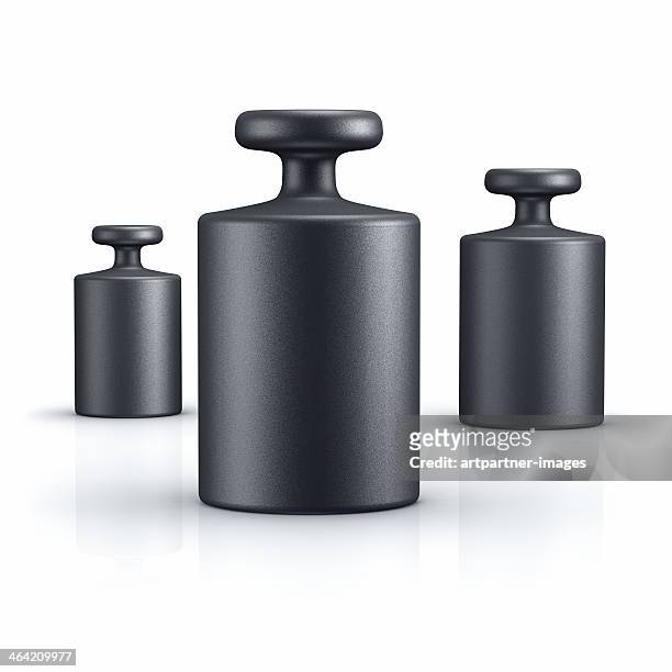 black weights of different size on white - mass unit of measurement stock pictures, royalty-free photos & images