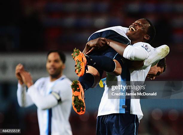 Dedryck Boyata of Manchester City lifts team mate Marcos Mesquita Lopes in celebration after victory in the Capital One Cup Semi-Final, Second Leg...