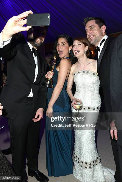 Director Bart Freundlich, actress Olivia Munn, actress Julianne Moore, and NFL player Aaron Rodgers pose for a selfie photo at the 2015 Vanity Fair...