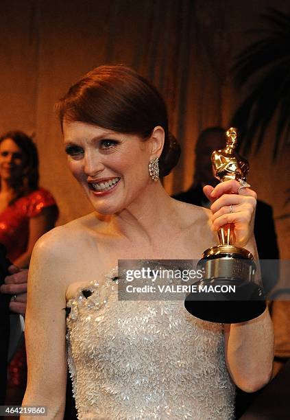 Winner for Best Actress Julianne Moore poses with her trophy at the Governor's Ball following the 87th Oscars February 22, 2015 in Hollywood,...