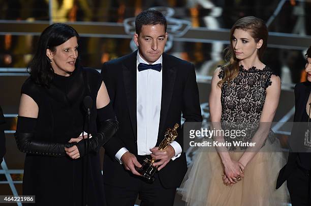 Director Laura Poitras, journalist Glenn Greenwald, and Lindsay Mills accept Best Documentary Feature for 'Citizenfour' onstage during the 87th...