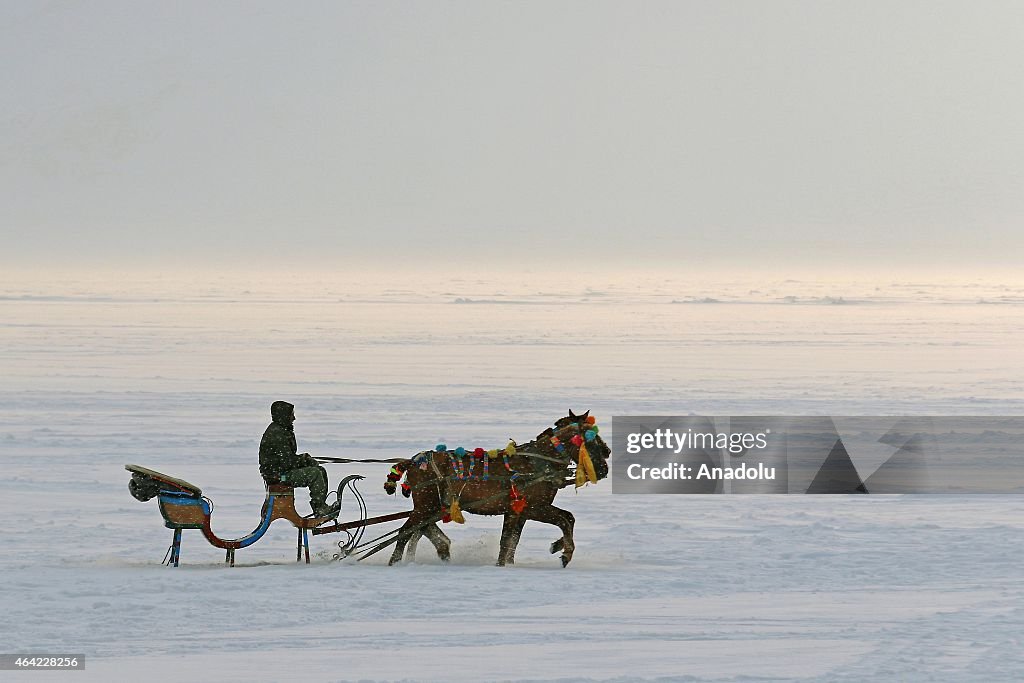 Horse drawn sleighs on ice over the Lake Cildir in Turkey