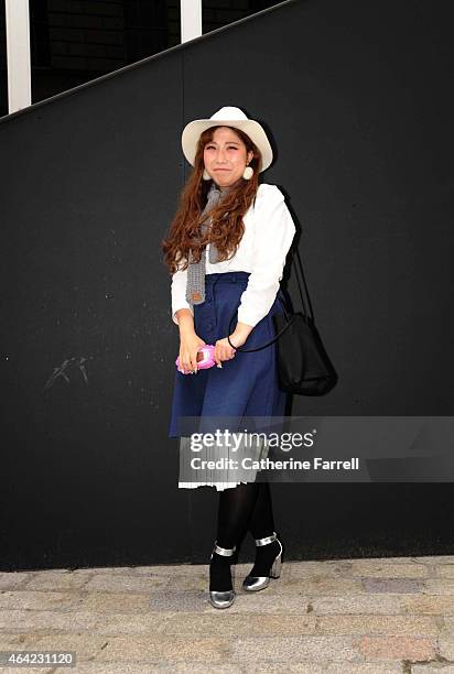 Hayley Hyejin, fashion student at UCA Epsom, wearing vintage Korean jacket, and skirts from Shinza store, accessorised with a Moschino rubber iphone...