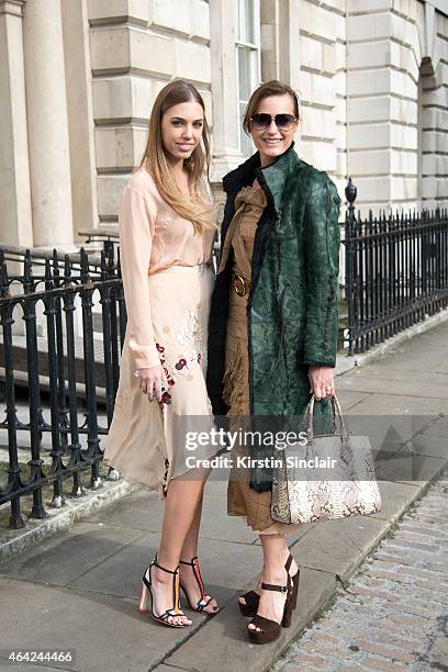 Model and DJ Amber Le Bon wears Palma Harding top and dress, Sophia Webster shoes and a Chanel handbag with super Model Yasmin Le Bon wearing a...