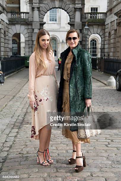 Model and DJ Amber Le Bon wears Palma Harding top and dress, Sophia Webster shoes and a Chanel handbag with super Model Yasmin Le Bon wearing a...