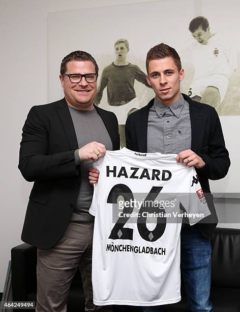 Director of Sport Max Eberl of Borussia Moenchengladbach and Thorgan Hazard of Borussia Moenchengladbach pose for a photo as he signs a new contract...