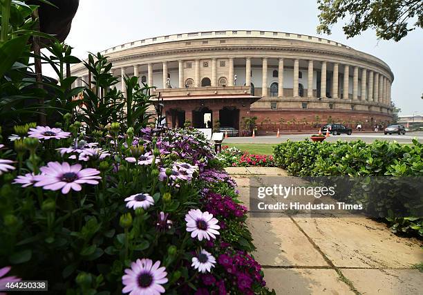 Parliament building seen the back drop of full bloom flowers during first Day of Budget Session on February 23, 2015 in New Delhi, India. The budget...