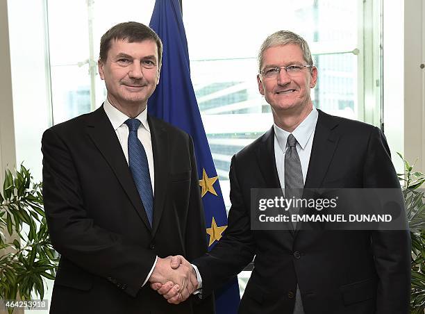 European Commission Vice-President and Commissioner for the Digital Single Market, Andrus Ansip shakes hands with Apple's Chief Executive Officer Tim...