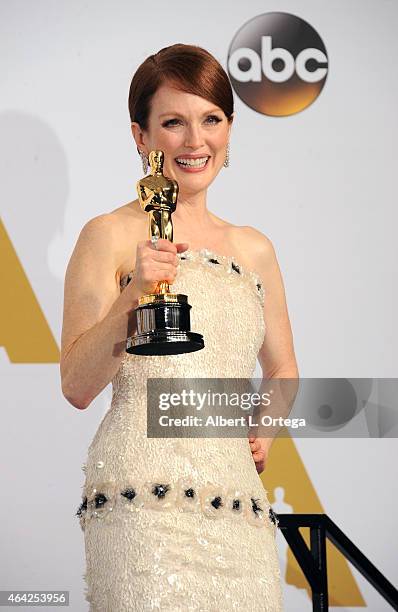 Actress Julianne Moore winner for Best Actress in "Still Alice" poses inside the press room of the 87th Annual Academy Awards held at Loews Hollywood...