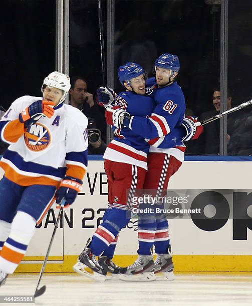 Rick Nash of the New York Rangers celebrates his goal at 1:02 of the first period against the New York Islanders along with Derek Stepan at Madison...