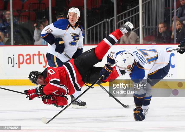 Ryan Carter of the New Jersey Devils is hit by Vladimir Sobotka of the St. Louis Blues in the first period at Prudential Center on January 21, 2014...