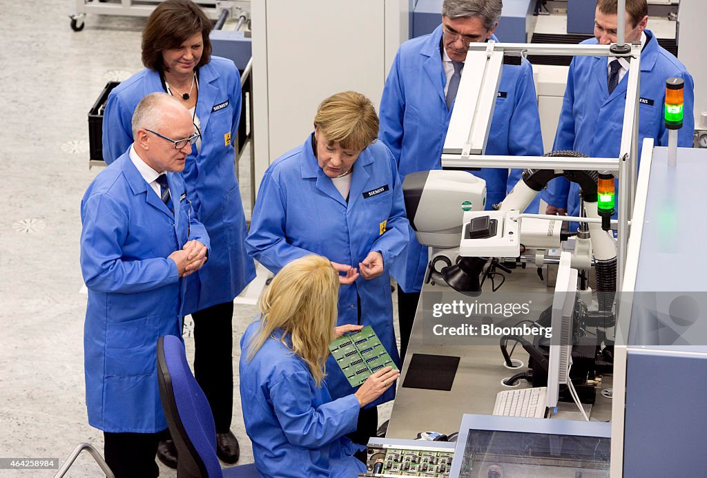 Germany's Chancellor Angela Merkel Visits Siemens AG Electronics Manufacturing Plant