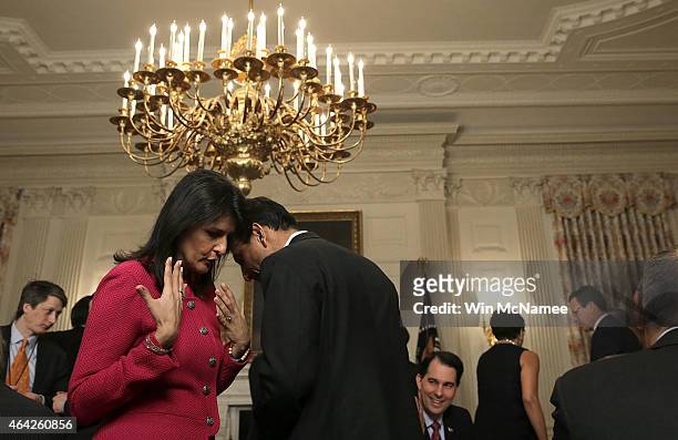 Louisiana Gov. Bobby Jindal talks with South Carolina Gov. Nikki Haley before U.S. President Barack Obama addressed members of the National Governors...