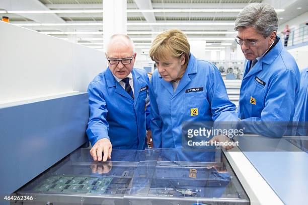 In this photo provided by the German Government Press Office , Professor Karl-Heinz Büttner , head of the Siemens plant in Amberg and Joe Kaeser ,...