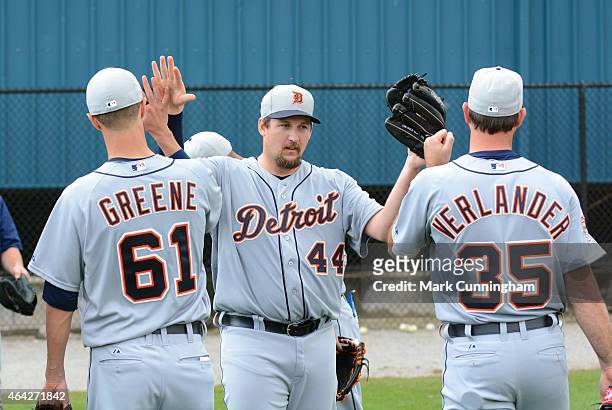 Joel Hanrahan of the Detroit Tigers gets high-fives from teammates Shane Greene and Justin Verlander after winning the annual rag ball competition...