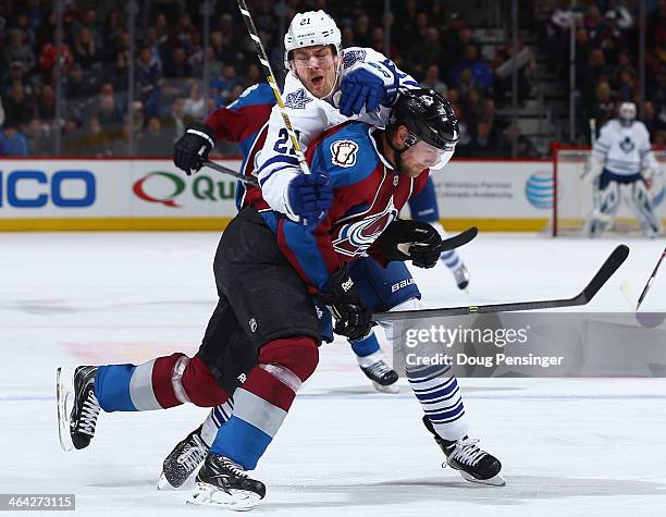 Jan Hejda of the Colorado Avalanche and James van Riemsdyk of the Toronto Maple Leafs collide during action at Pepsi Center on January 21, 2014 in...