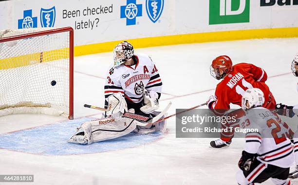 Mike Moran of the Boston University Terriers scores against Clay Witt of the Northeastern Huskies during the first period of NCAA hockey in the...