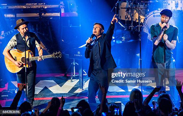 Mark Owen, Gary Barlow and Howard Donald of Take That perform on stage for the War Child BRITs show at O2 Shepherd's Bush Empire on February 23, 2015...