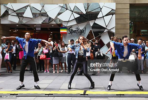 Shoppers look on as Simeon Henri, Prinnie Stevens and Joe Drum perform during a Michael Jackson 'Moonwalking' demonstration at Pitt St Mall on...