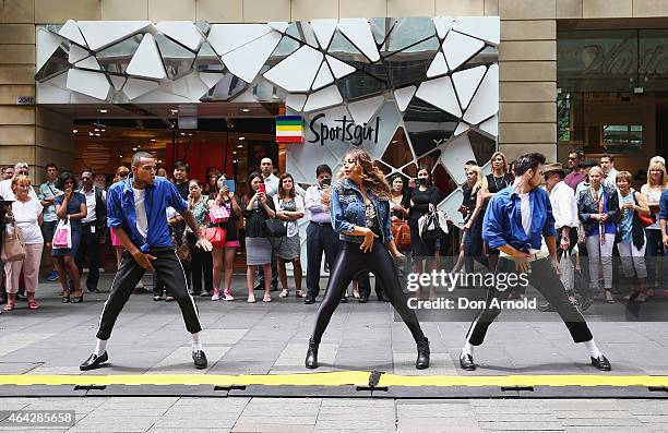 Shoppers look on as Simeon Henri, Prinnie Stevens and Joe Drum perform during a Michael Jackson 'Moonwalking' demonstration at Pitt St Mall on...