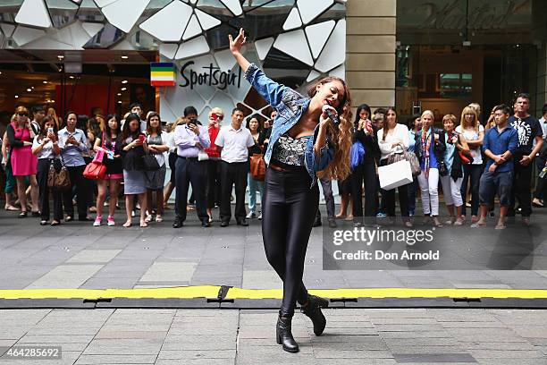 Shoppers look on as Prinnie Stevens performs during a Michael Jackson 'Moonwalking' demonstration at Pitt St Mall on February 24, 2015 in Sydney,...