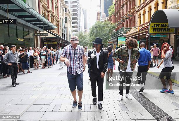 Sean Christopher gives dancing tips to interested shoppers during a Michael Jackson 'Moonwalking' demonstration at Pitt St Mall on February 24, 2015...