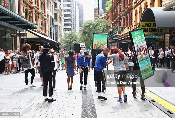 Sean Christopher gives dancing tips to interested shoppers during a Michael Jackson 'Moonwalking' demonstration at Pitt St Mall on February 24, 2015...