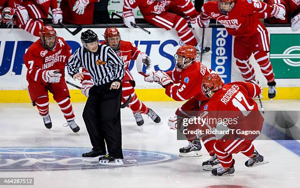 Matt Grzelcyk of the Boston University Terriers celebrates his overtime winning goal against the Northeastern Huskies with teammates Evan Rodrigues,...