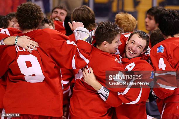 Cason Hohmann, right, and Evan Rodrigues celebrate the Terriers 4-3 win over the Northeastern Huskies in overtime during the 2015 Beanpot Tournament...