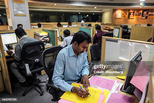 Employees work in an office at the Blue Dart Express Ltd. And DHL Express India Pvt. Joint hub in Cargo Terminal 3 at Kempegowda International...