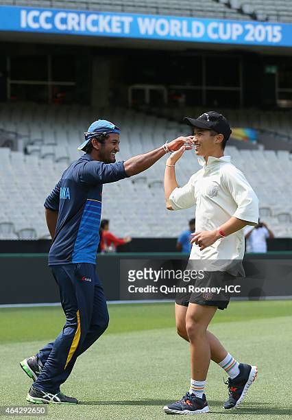 Dimuth Karunaratne of Sri Lanka high fives a cricketer from Geelong Grammar School after getting a wicket during an ICC Charity Session at Melbourne...