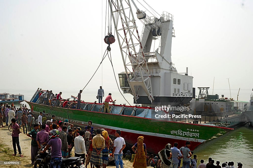 Bangladeshi rescue workers recover the capsied ferry at...