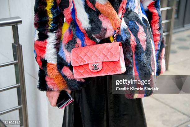 Fashion journalism student Maddy Killick wears a Story of Lola Coat, Chanel bag, Topshop skirt on February 23, 2015 in London, England.